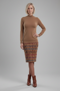 A woman modeling a fitted tan mock-neck long-sleeve sweater paired with a brown, red, and blue plaid pencil skirt, shown against a plain white background.