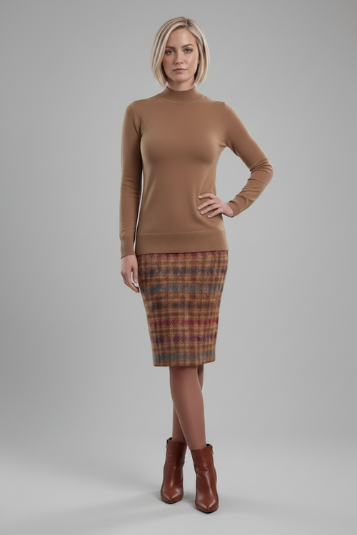 A woman modeling a fitted tan mock-neck long-sleeve sweater paired with a brown, red, and blue plaid pencil skirt, shown against a plain white background.